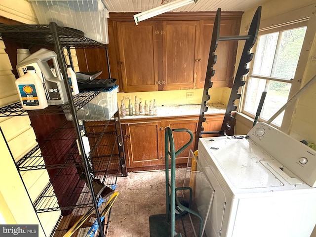 laundry room with washer and clothes dryer and cabinet space