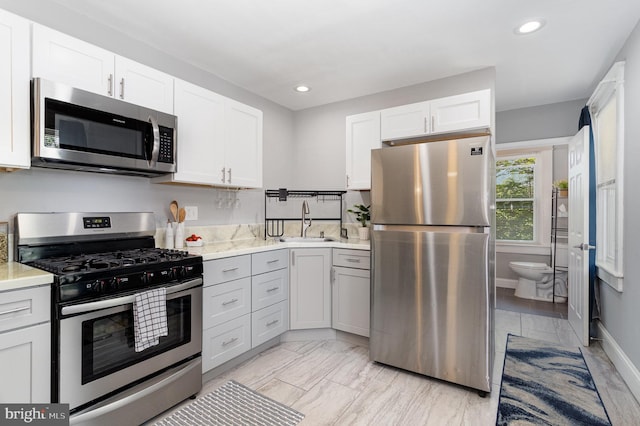442 Poplar St, Lancaster, PA 17603 - kitchen with stainless steel appliances, a sink, light countertops, recessed lighting, and white cabinets