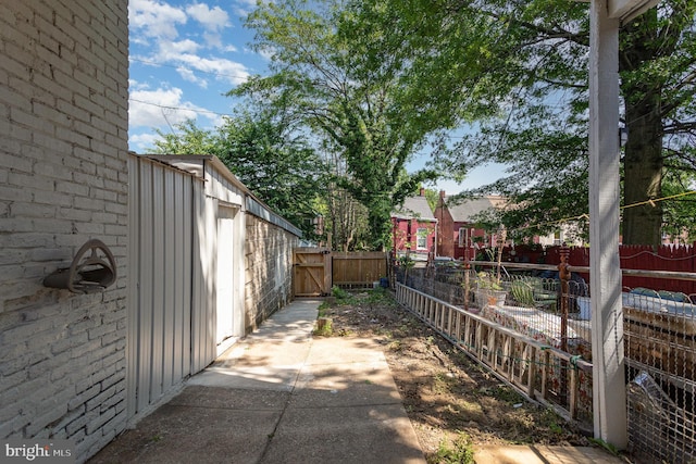 442 Poplar St, Lancaster, PA 17603 - view of side of home with board and batten siding, a fenced backyard, and a gate