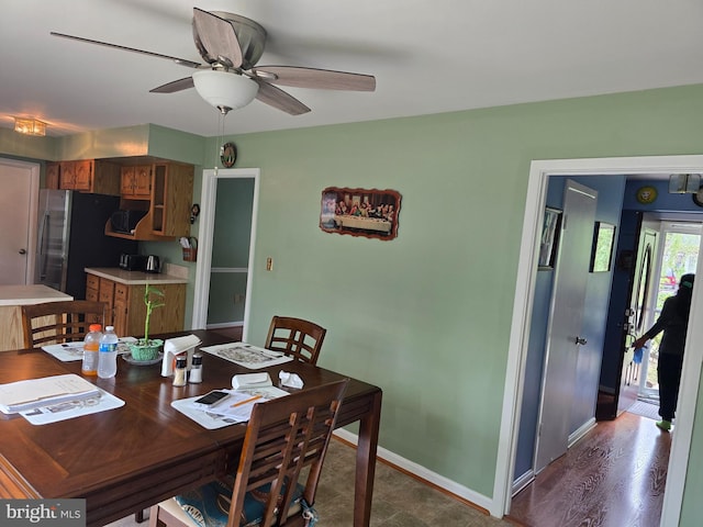 dining area with baseboards and ceiling fan