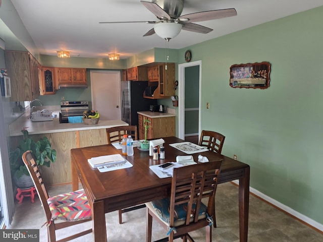 dining room with baseboards and a ceiling fan