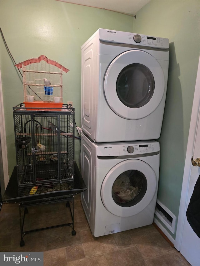 laundry area with laundry area and stacked washer and clothes dryer