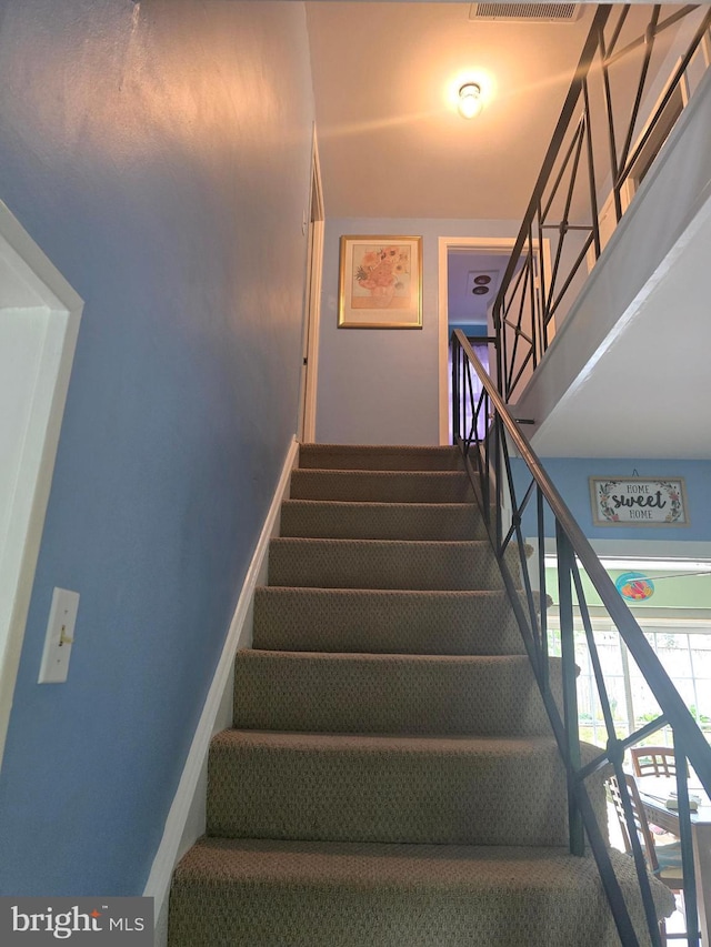 stairway featuring baseboards