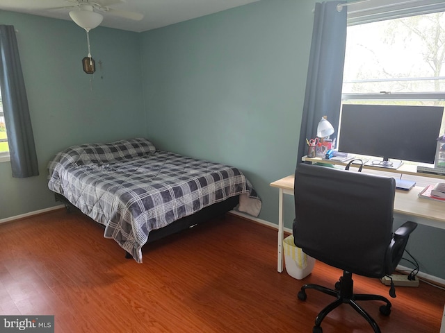 bedroom featuring wood finished floors and baseboards