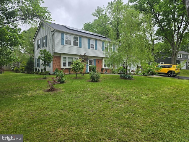 colonial house with brick siding and a front lawn