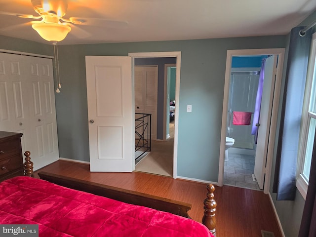 bedroom with baseboards and wood finished floors