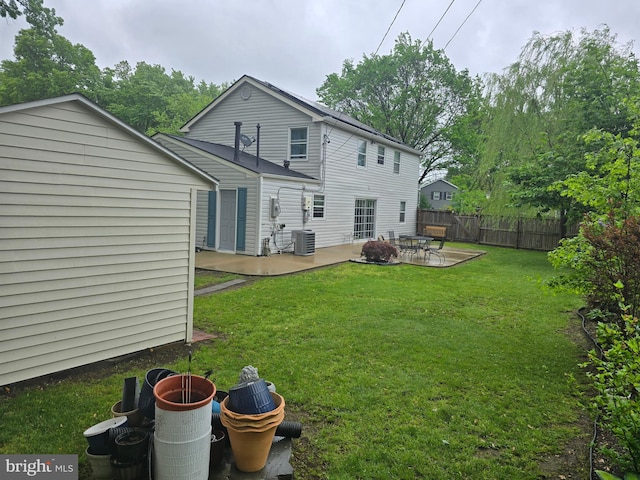 rear view of house featuring a yard, central air condition unit, a patio, and fence
