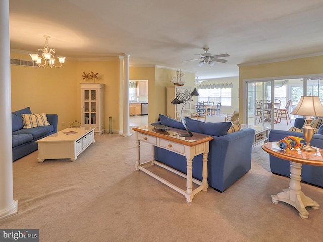living area with light carpet, ornamental molding, ceiling fan with notable chandelier, and ornate columns