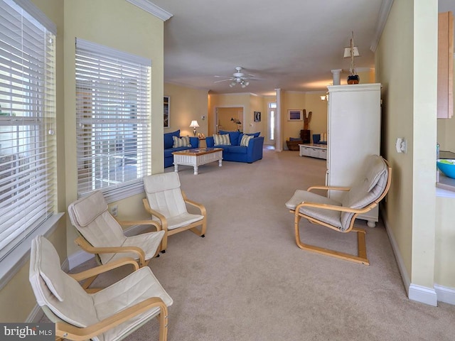 living area with carpet floors, a ceiling fan, and baseboards