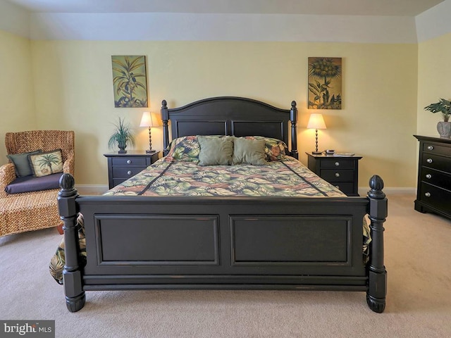 bedroom with baseboards and light colored carpet
