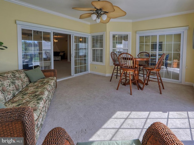 sunroom / solarium with ornamental molding, carpet floors, and plenty of natural light