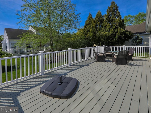 wooden terrace with an outdoor hangout area