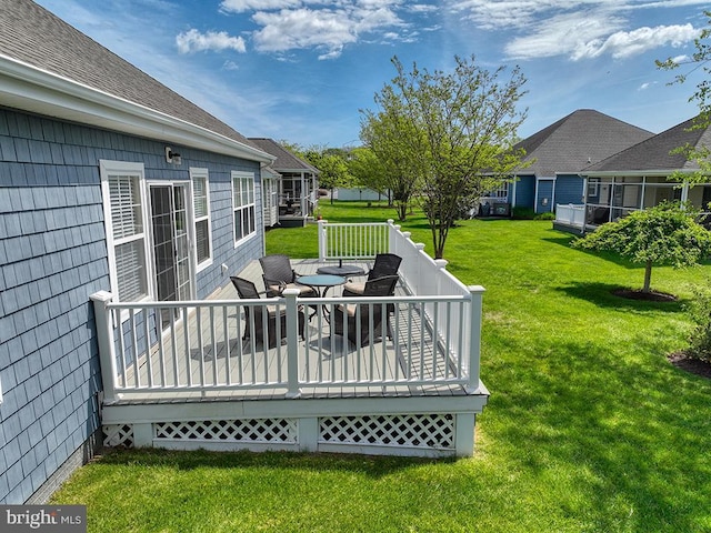 wooden terrace featuring a yard