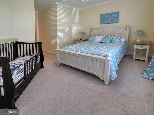 carpeted bedroom featuring baseboards and crown molding