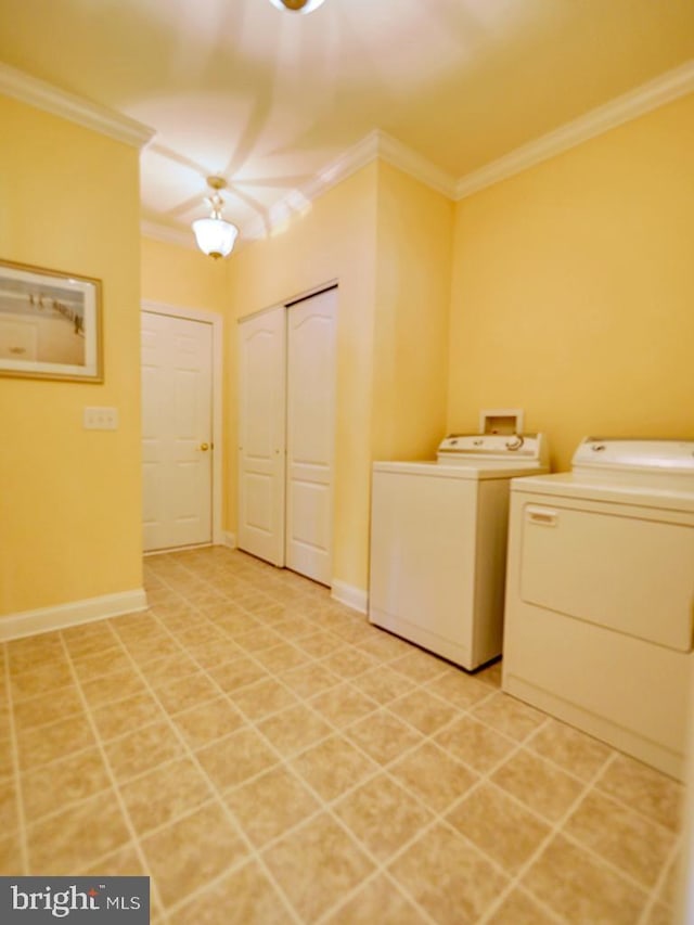 laundry room with washer and clothes dryer, crown molding, and baseboards