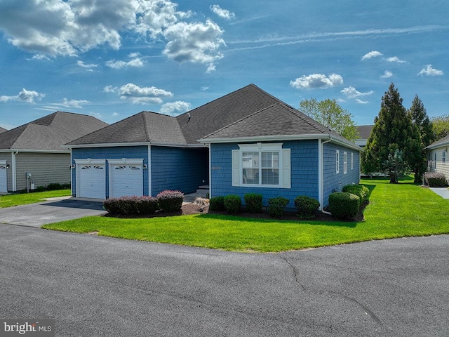 ranch-style home with a front yard, roof with shingles, aphalt driveway, and an attached garage