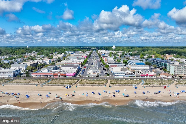 aerial view with a water view and a beach view