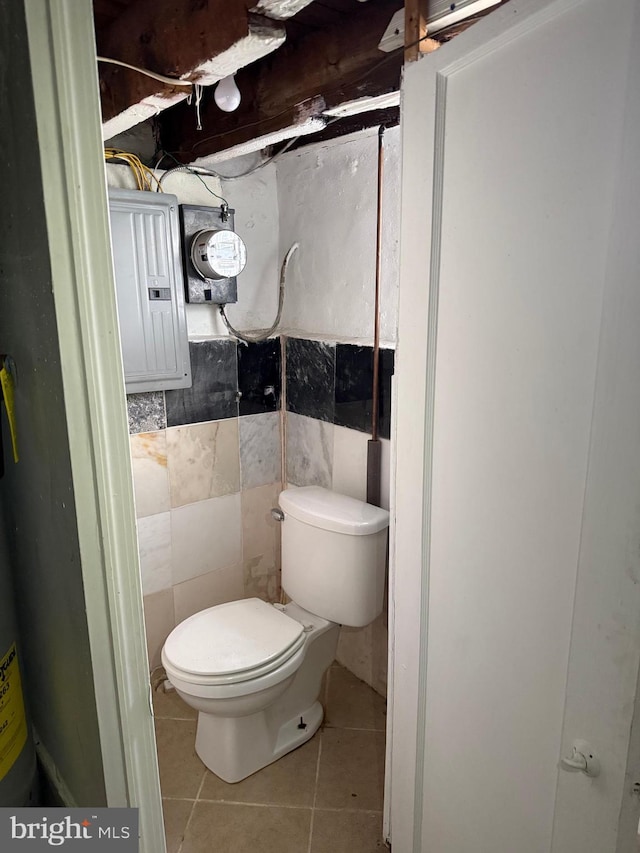2302 E Albert St, Philadelphia, PA 19125 - bathroom with electric panel, toilet, tile walls, and tile patterned floors