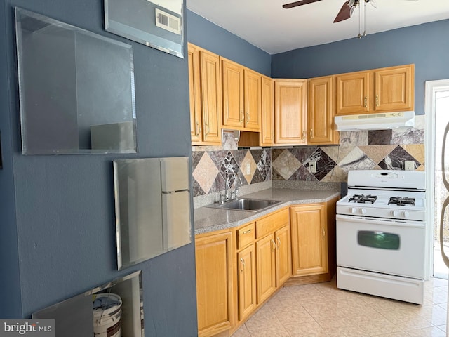 2302 E Albert St, Philadelphia, PA 19125 - kitchen featuring a sink, white range with gas cooktop, under cabinet range hood, ceiling fan, and decorative backsplash