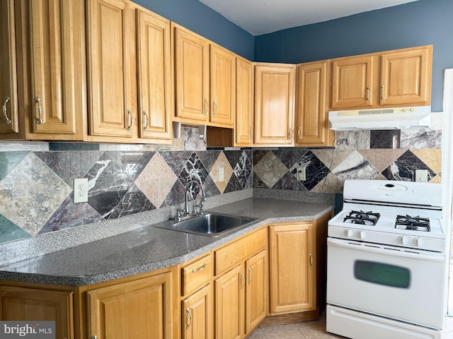 2302 E Albert St, Philadelphia, PA 19125 - kitchen with a sink, tasteful backsplash, white gas range, under cabinet range hood, and dark countertops
