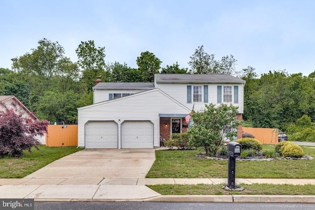 33 Miracle Dr, Williamstown, NJ 08094 - view of front of home with an attached garage, a front lawn, concrete driveway, a chimney, and brick siding