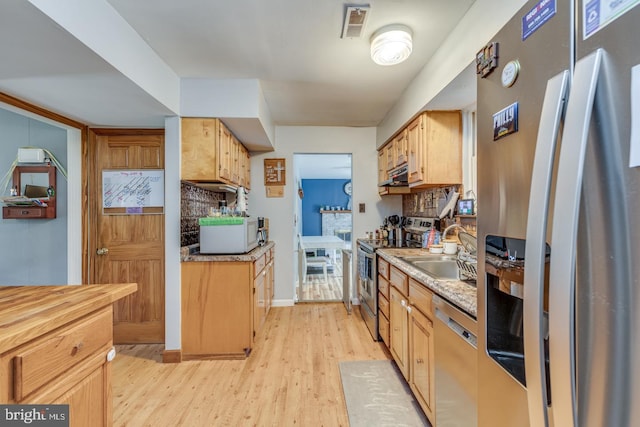 33 Miracle Dr, Williamstown, NJ 08094 - kitchen featuring stainless steel appliances, under cabinet range hood, light wood finished floors, a sink, and light countertops