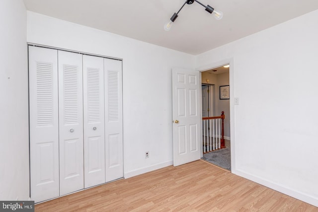 33 Miracle Dr, Williamstown, NJ 08094 - unfurnished bedroom featuring light wood-style floors, baseboards, and a closet