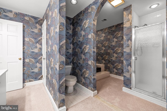 bathroom featuring toilet, a shower stall, wallpapered walls, and visible vents