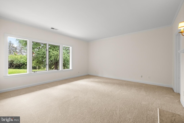 spare room with light carpet, baseboards, a healthy amount of sunlight, and visible vents