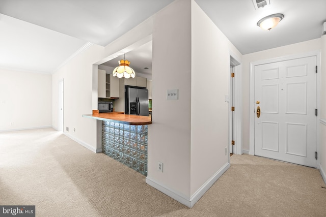 hall featuring ornamental molding, carpet floors, baseboards, and visible vents