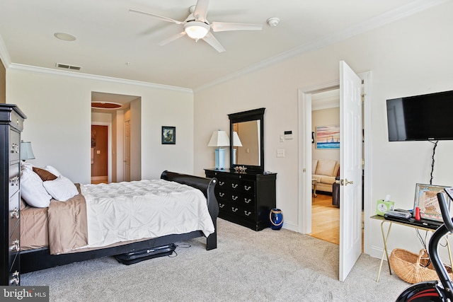 carpeted bedroom featuring crown molding, baseboards, ceiling fan, and visible vents