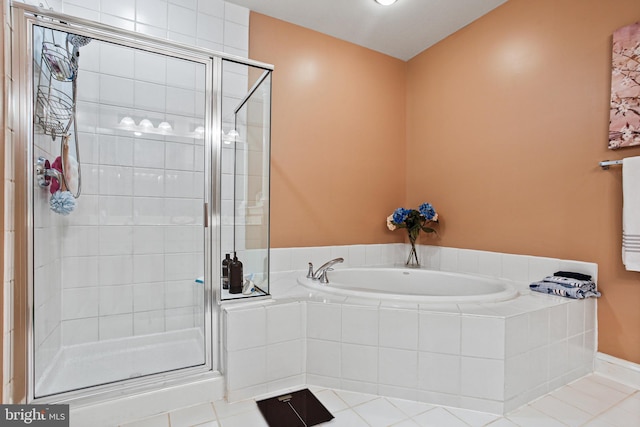 full bath with a stall shower, a garden tub, and tile patterned floors