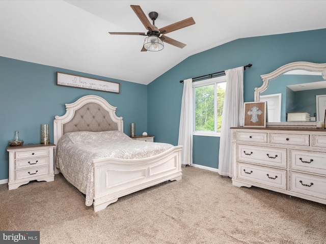 bedroom with lofted ceiling, light colored carpet, baseboards, and ceiling fan