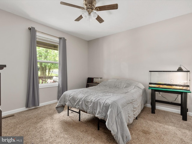 carpeted bedroom with baseboards and a ceiling fan