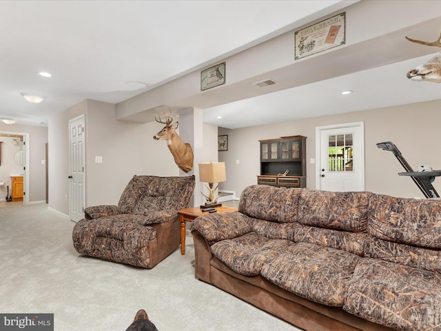 carpeted living area with recessed lighting and baseboards