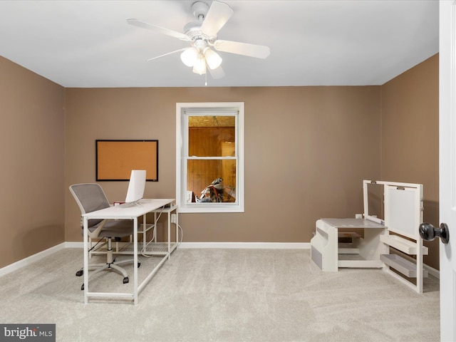 carpeted office featuring ceiling fan and baseboards