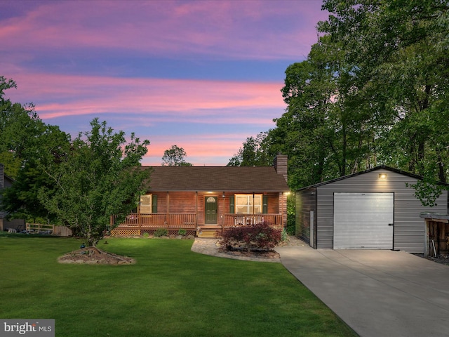 view of front facade featuring concrete driveway, an outdoor structure, a garage, a front yard, and a chimney