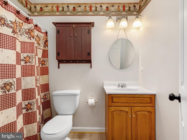 bathroom with tile patterned flooring, vanity, toilet, and baseboards