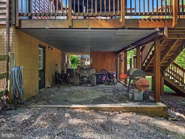 view of patio featuring stairs, central air condition unit, and a carport