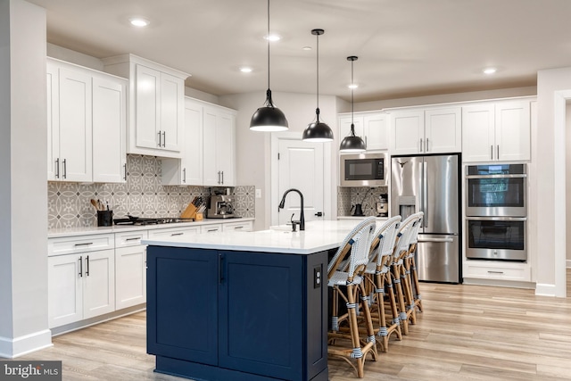 7679 Cross Creek Dr, Columbia, MD 21044 - kitchen with appliances with stainless steel finishes, a sink, backsplash, white cabinetry, and light wood-style floors