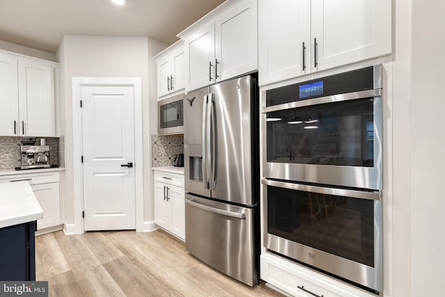 7679 Cross Creek Dr, Columbia, MD 21044 - kitchen featuring stainless steel appliances, backsplash, light wood finished floors, white cabinets, and recessed lighting