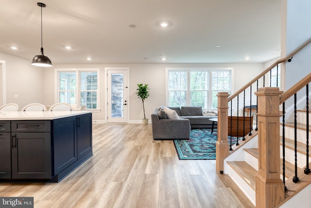 7679 Cross Creek Dr, Columbia, MD 21044 - kitchen featuring light wood-style flooring, plenty of natural light, recessed lighting, light countertops, and hanging light fixtures