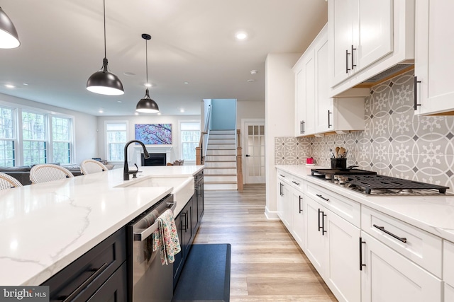 7679 Cross Creek Dr, Columbia, MD 21044 - kitchen featuring stainless steel appliances, a sink, white cabinets, light wood finished floors, and recessed lighting