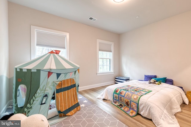 7679 Cross Creek Dr, Columbia, MD 21044 - bedroom with multiple windows, wood finished floors, and baseboards
