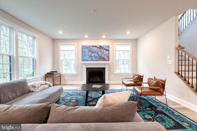 7679 Cross Creek Dr, Columbia, MD 21044 - living area with stairway, wood finished floors, baseboards, a fireplace, and recessed lighting