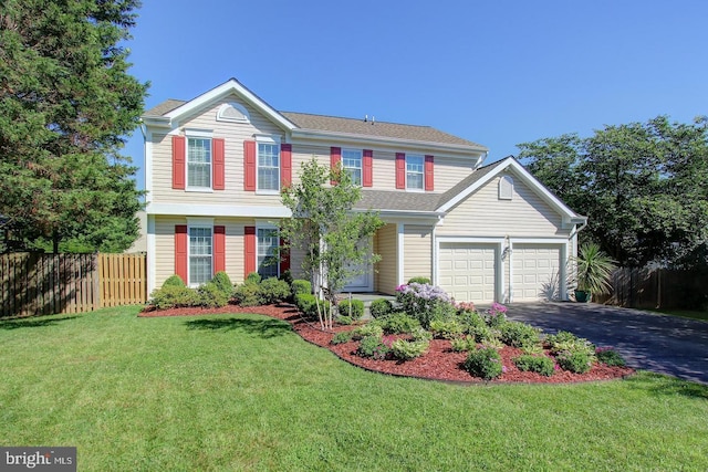 view of front of home with asphalt driveway and a garage