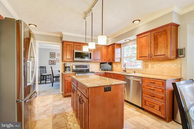 kitchen featuring appliances with stainless steel finishes, a sink, a center island, brown cabinetry, and light stone counters
