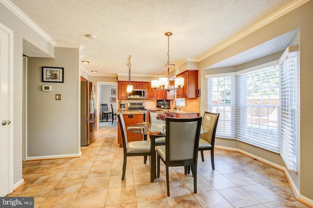 dining room with a chandelier, a textured ceiling, baseboards, crown molding, and light tile patterned floors