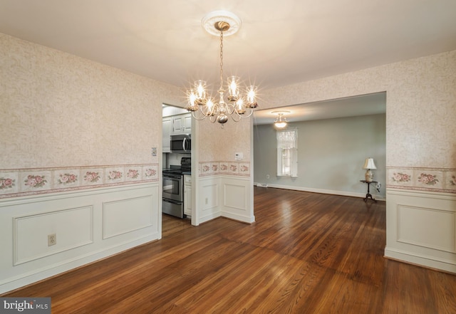 1149 Ollerton Rd, West Deptford, NJ 08066 - unfurnished dining area with wallpapered walls, a chandelier, wainscoting, dark wood-style flooring, and a decorative wall