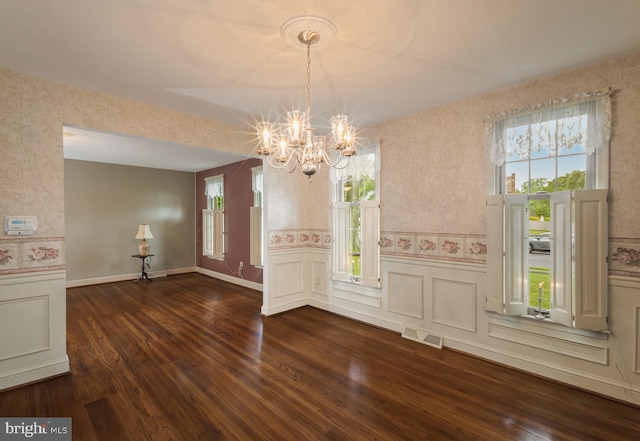 1149 Ollerton Rd, West Deptford, NJ 08066 - unfurnished dining area with a chandelier, a wainscoted wall, dark wood-style flooring, and a decorative wall